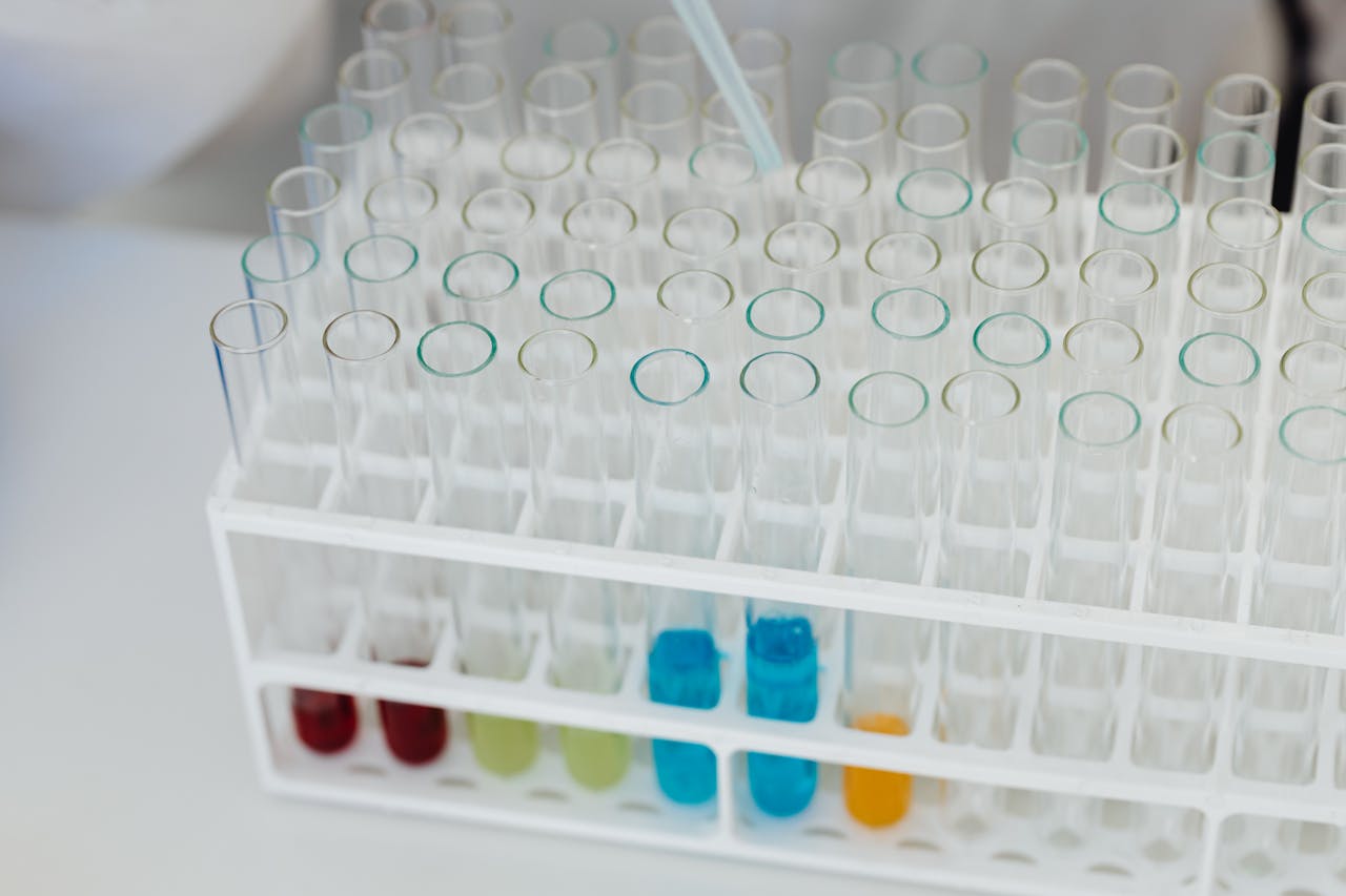 Close-up of a laboratory test tube rack with colorful chemical solutions, emphasizing scientific research.